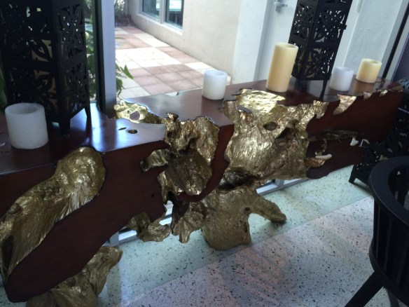 This is the root of a tree cut into a table and gold leafed.  yup.....